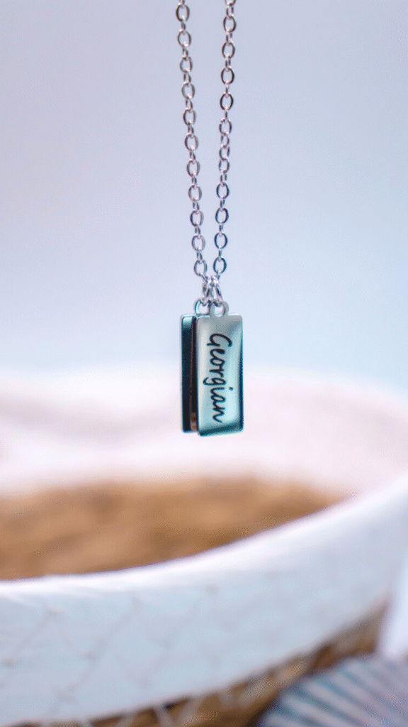 Two silver rectangular pendants on a silver chain with 'Georgian Bay' engraved on them.